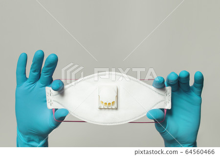Hands wearing doctor gloves showing medical face Hands wearing doctor gloves showing medical face 64560466