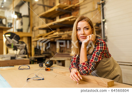 tired caucasian woman carpenter tired caucasian woman carpenter 64560804