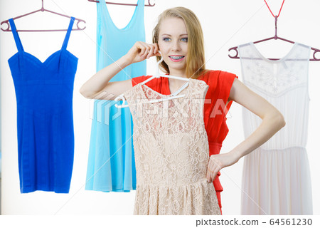 Woman choosing clothes in shop Woman choosing clothes in shop 64561230