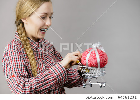 Woman holding shopping cart with brain 64561231