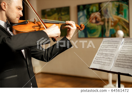 young caucasian talented violinist play violin 64561472