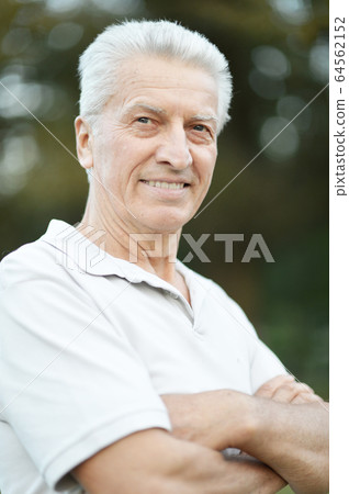 Portrait of happy senior man in park Portrait of happy senior man in park 64562152