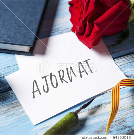 red rose, book and text postponed in Catalan red rose, book and text postponed in Catalan 64563016