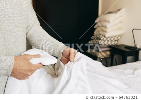 caucasian man making the bed caucasian man making the bed 64563021