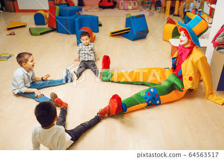 Funny clown play with boys in kindergarten Funny clown play with boys in kindergarten 64563517