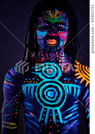 fashionable male model with fluorescent UV body art fashionable male model with fluorescent UV body art 64563781