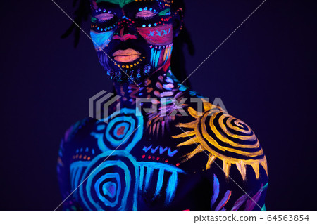 mysterious male with fluorescent body art 64563854