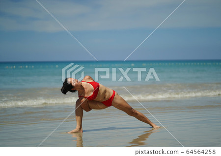 Asian Chinese Woman in various yoga poses at the 64564258