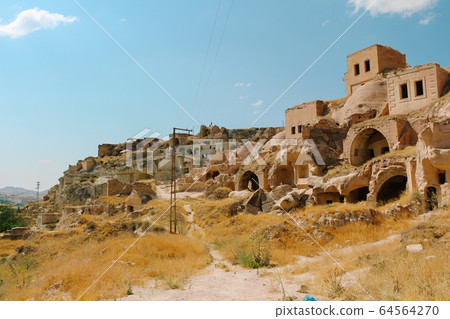 Cavusin old village, cave town in Cappadocia, Turkey 64564270