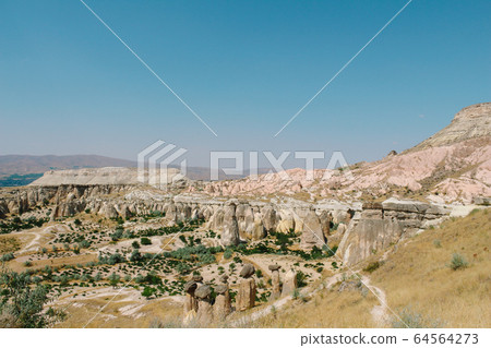 Cavusin old village, cave town in Cappadocia, Turkey 64564273