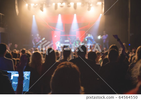 The audience watching the concert on stage. The audience watching the concert on stage. 64564550
