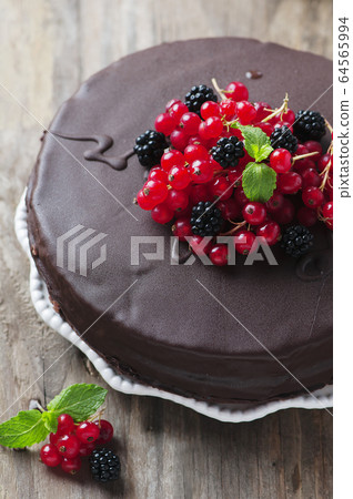 Chocolate cake with berry and mint 64565994