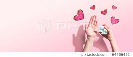 Applying sanitizer for cleaning hands with heart drawings Applying sanitizer for cleaning hands with heart drawings 64566431