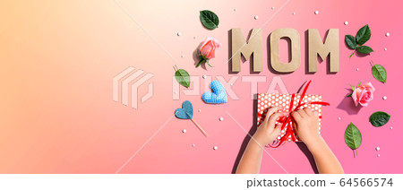 Little boy making a gift box for his mother 64566574