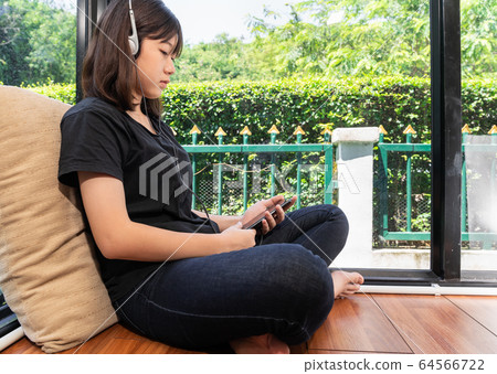Teenage female listening to the music from Teenage female listening to the music from 64566722