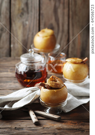Baked apples with honey and cinnamon on the wooden 64566723