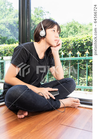 Teenage female listening to the music from Teenage female listening to the music from 64566724