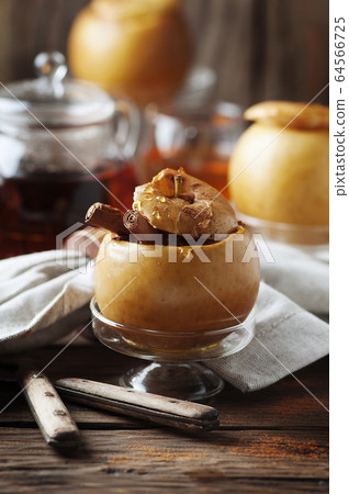 Baked apples with honey and cinnamon on the wooden Baked apples with honey and cinnamon on the wooden 64566725
