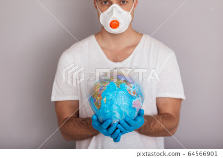 Man is wearing mask holding globe in plastic bag. Covid concept. Isolated white background Man is wearing mask holding globe in plastic bag. Covid concept. Isolated white background 64566901