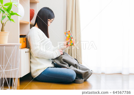 Woman putting glasses case in backpack, taking out 16: 9 64567786