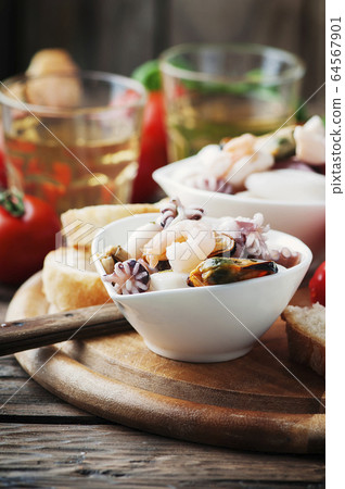 Seafood salad with white wine 64567901