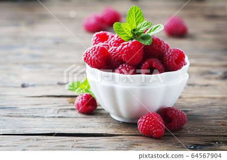 Sweet fresh raspberry and mint on the wooden table Sweet fresh raspberry and mint on the wooden table 64567904