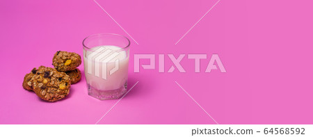 Cereal, chocolate, cookies and milk in a glass on Cereal, chocolate, cookies and milk in a glass on 64568592
