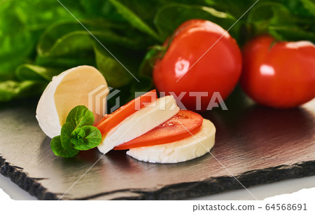 mozzarella cheese with tomatoes and spinach mozzarella cheese with tomatoes and spinach 64568691