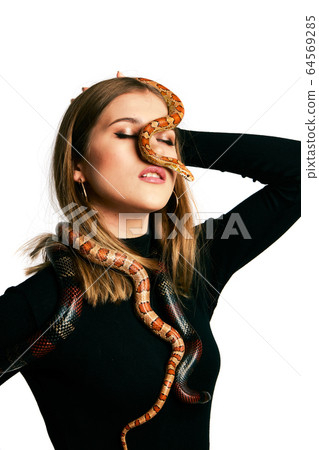 Beautiful woman in black bodywear and snake. Beautiful woman in black bodywear and snake. 64569285
