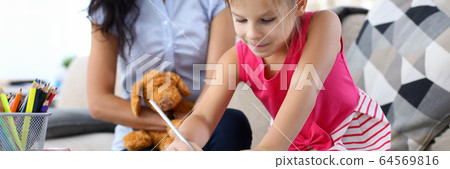 Mum teaching concentrated kid Mum teaching concentrated kid 64569816