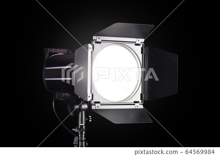 Photography studio flash isolated on black background with lamp. Photography studio flash isolated on black background with lamp. 64569984