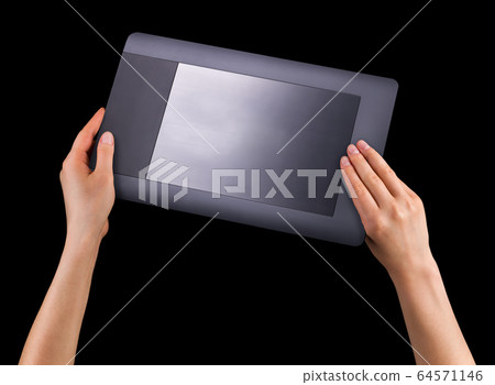 Hand holding graphic tablet for illustratorsand designers isolated on black 64571146