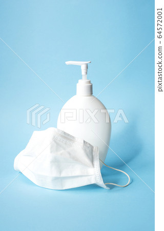White plastic bottle with hand sanitizer gel and surgical mask. White plastic bottle with hand sanitizer gel and surgical mask. 64572001