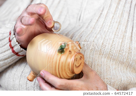 Savings, money, annuity insurance, retirement and people concept - close up of senior man hand 64572417