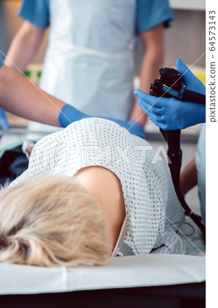 Patient and doctor in hospital during colonoscopy 64573143