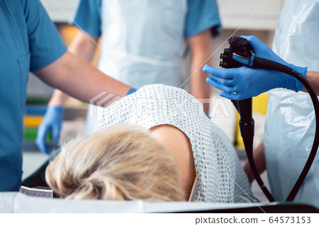 Patient and doctor in hospital during colonoscopy Patient and doctor in hospital during colonoscopy 64573153