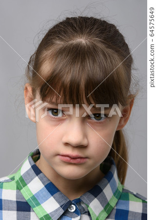 Portrait of a ten-year-old girl with a piercing 64575649