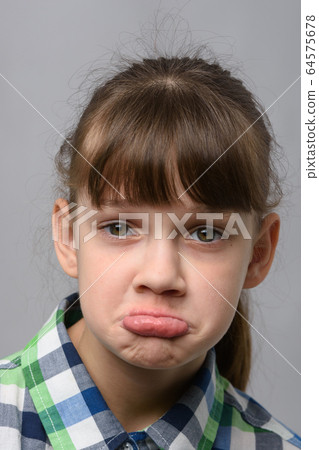 Portrait of a displeased ten-year-old girl of 64575678