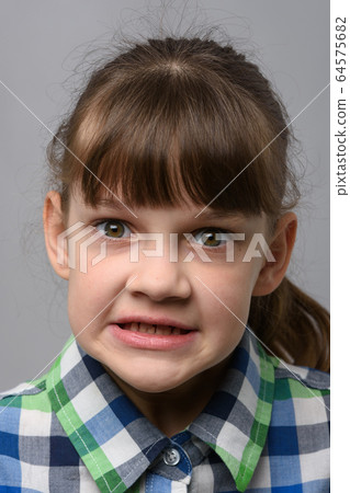 Portrait of an evil ten-year-old girl of European 64575682