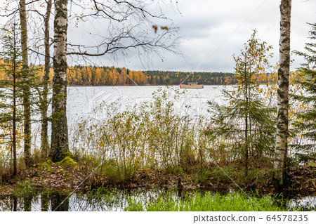 Drone view point of Wooden boat bath on a lake, water area in Autumn with lake Boroye, Valday national park, Russia, panoramic image, golden trees, Wooden lodges, cloudy weather Drone view point of Wooden boat bath on a lake, water area in Autumn with lake Boroye, Valday national park, Russia, panoramic image, golden trees, Wooden lodges, cloudy weather 64578235