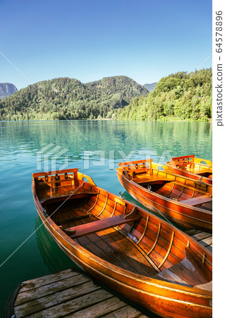 Lake Bled and wooden boats in Slovenia 64578896