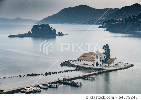 Monastery Vlacherna and the Mouse Island at clouds rainy weather, sea gulf, the airport runway is nearby, Kanoni, Corfu, Greece 64579245