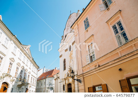 Franciscan church and old town street in Bratislava, Slovakia 64579877