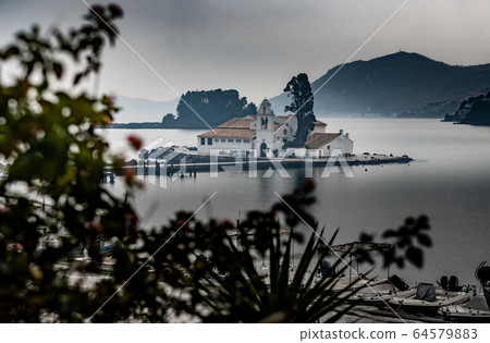 Monastery Vlacherna and the Mouse Island at clouds rainy weather, sea gulf, the airport runway is nearby, Kanoni, Corfu, Greece Monastery Vlacherna and the Mouse Island at clouds rainy weather, sea gulf, the airport runway is nearby, Kanoni, Corfu, Greece 64579883