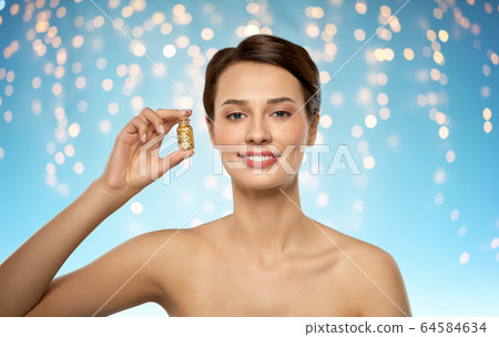 beautiful young woman with gold facial mask beautiful young woman with gold facial mask 64584634