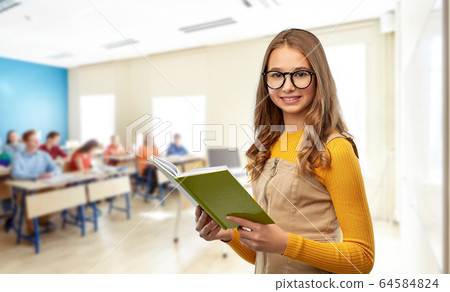 teenage student girl in glasses reading book teenage student girl in glasses reading book 64584824
