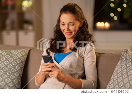 woman with smartphone at home 64584902