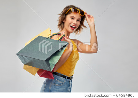 happy smiling young woman with shopping bags 64584903