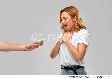 happy couple in white t-shirts with christmas gift 64584904