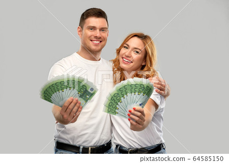 happy couple in white t-shirts with euro money happy couple in white t-shirts with euro money 64585150